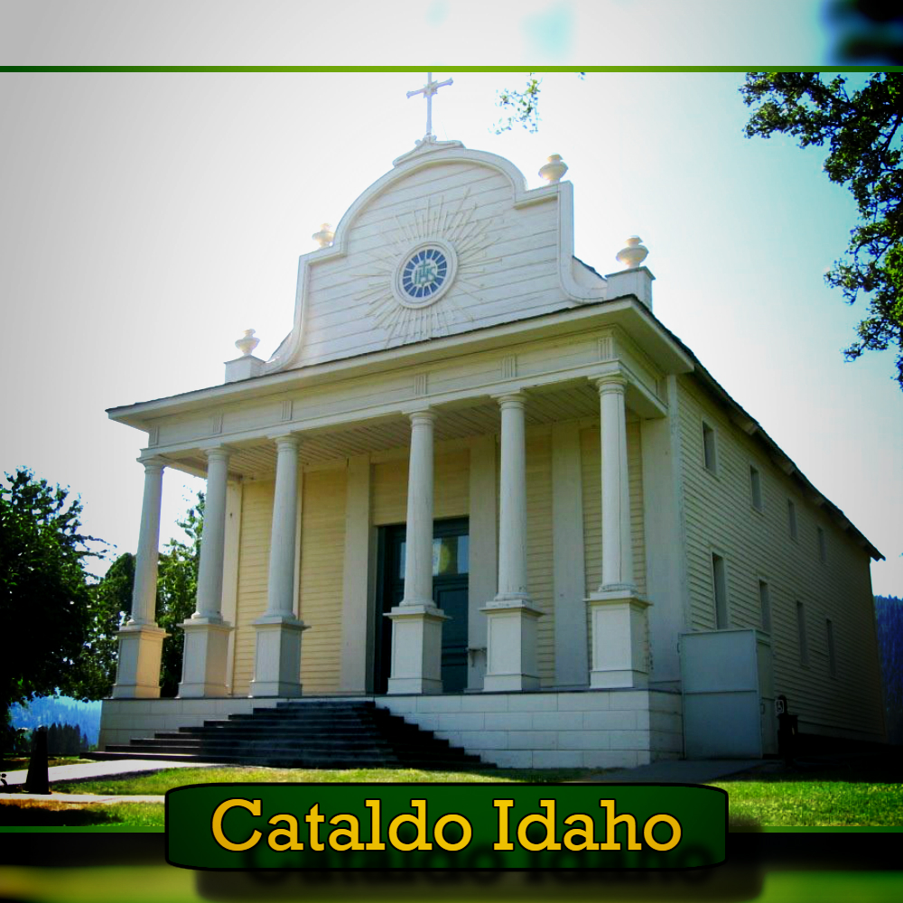 A white, historic church with large columns and a cross on top in Cataldo, Idaho, surrounded by green grass and trees. A tow truck passing by adds to the modern-day charm. Text at the bottom reads, "Cataldo Idaho.