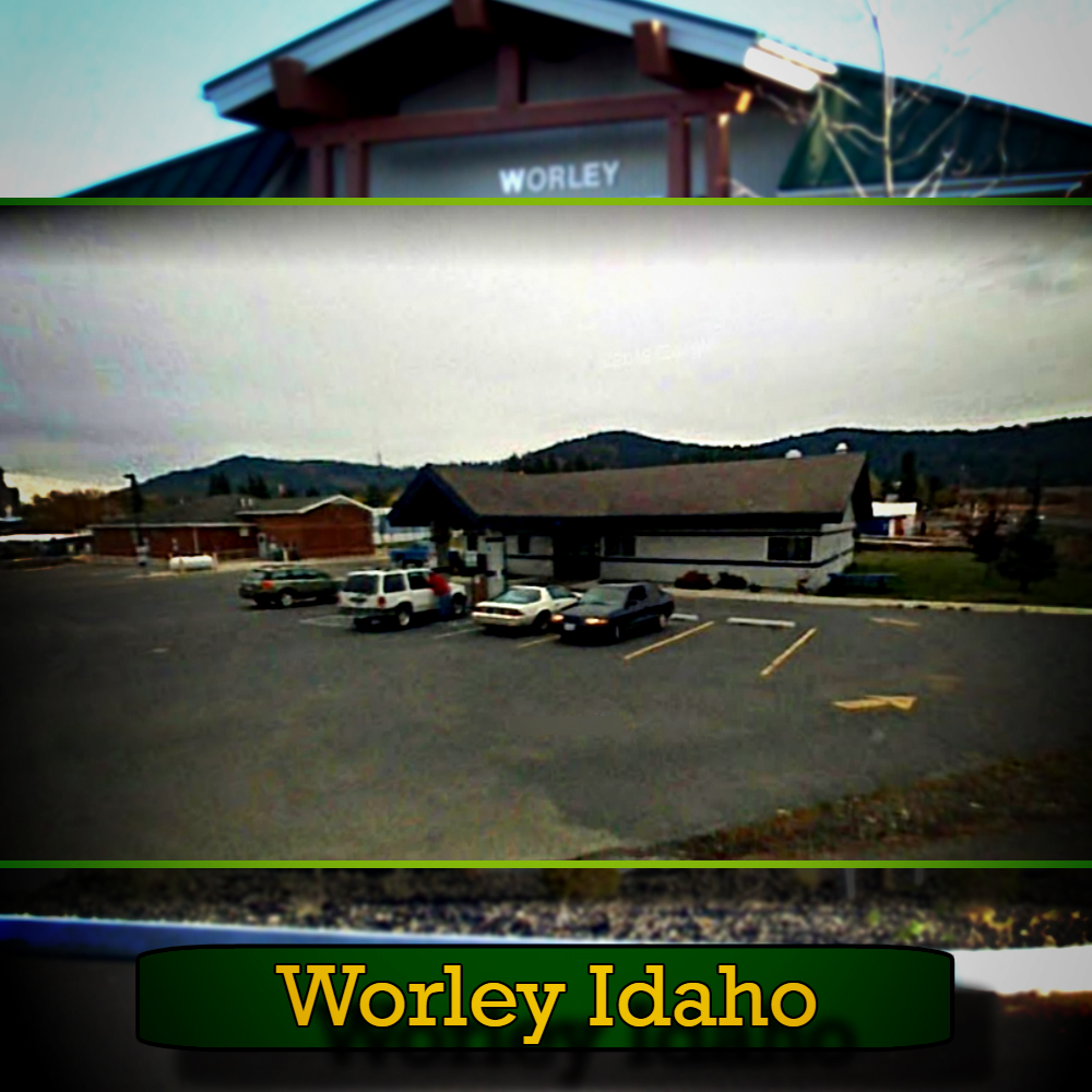 Image of a parking lot with several cars parked in front of a one-story building, including a tow truck. The caption at the bottom reads "Worley Idaho." A sign on the building also displays "Worley.